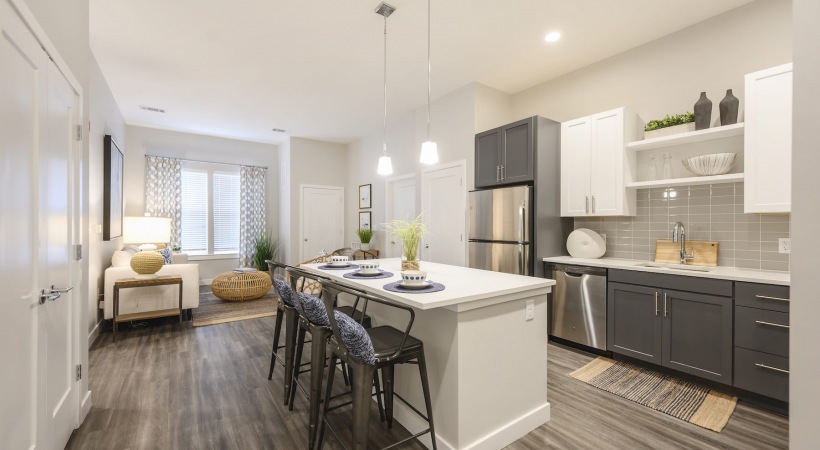 Life at Harborwalk Furnished dining and kitchen area with hardwood-style flooring