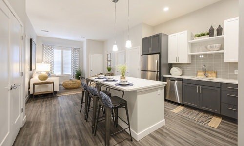 open concept apartment interiors, kitchen with island and pendant lighting